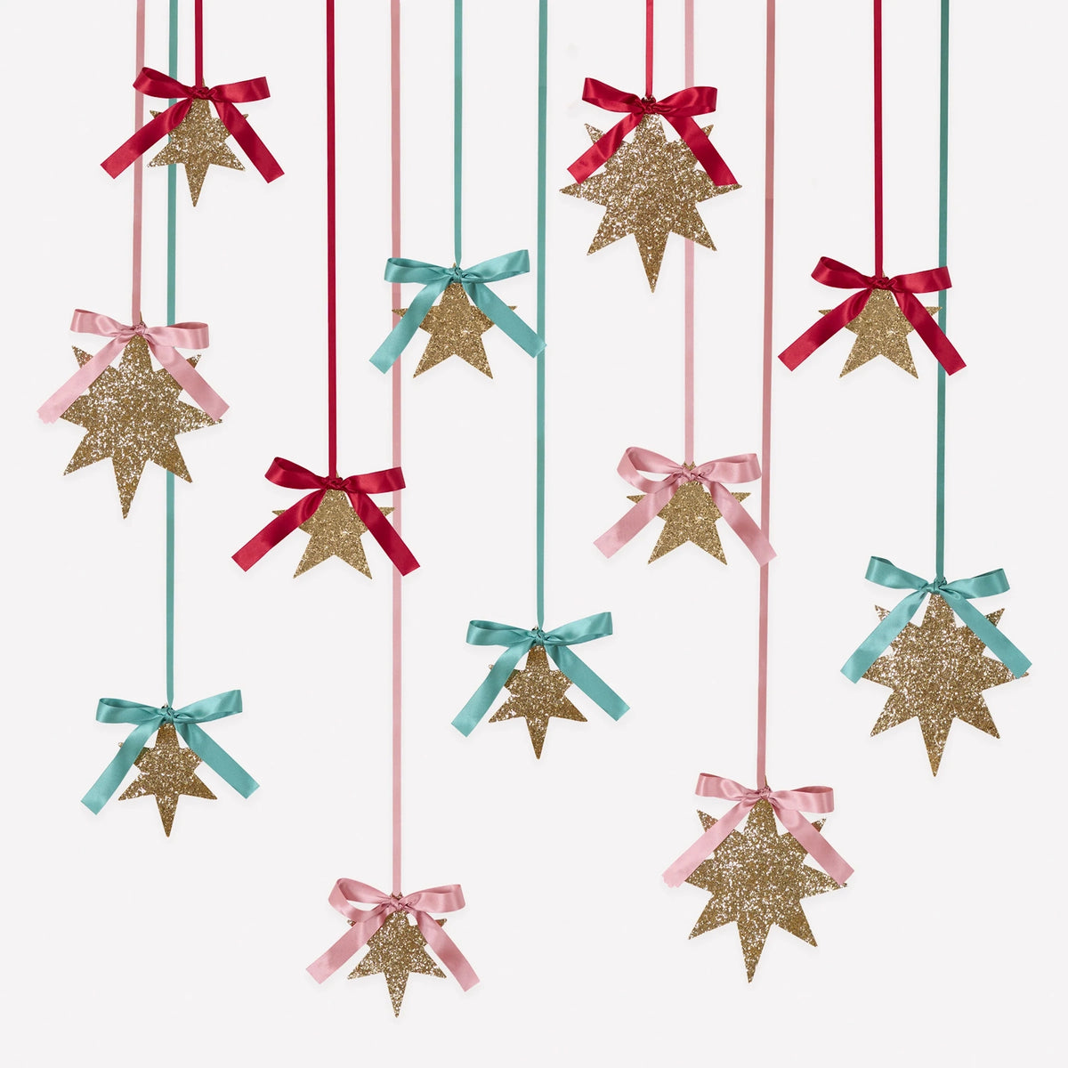 Gold glitter star hanging decorations featuring satin ribbons and bows in shades of red, light pink, and mint green.