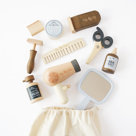 Wooden hairdresser and barber toy kit with scissors, hairdryer, mirror, comb, and accessories.