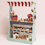 Wooden market stall play set with a red-striped awning, toy cash register, coffee machine, and food.