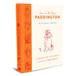 Book cover of "How to Be More Paddington" by Michael Bond. Features an illustration of Paddington Bear with a hat and suitcase, conveying warmth and kindness.