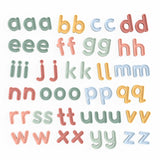Colorful alphabet letters in playful fonts, arranged in rows by letter. Each letter appears multiple times in various pastel shades, creating a whimsical feel.