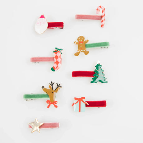 Set of velvet Christmas hair clips with festive charms including Santa, a tree, and reindeer.