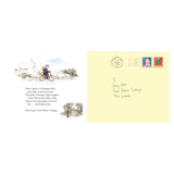 Illustration of a postman riding a bike through snowy countryside, carrying a sack. Next to it, an envelope addressed to "Baby Bear, Four Bears Cottage, The Woods" with festive stamps, conveying a whimsical, festive tone.