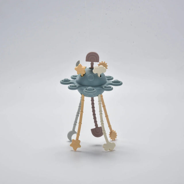 Blue silicone baby pull toy with hanging shapes shown standing in a front view.
