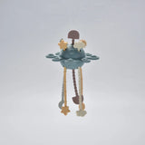 Blue silicone baby pull toy hanging in a front view.