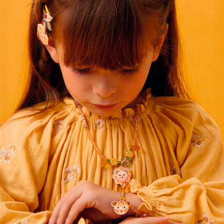 Young girl wearing a Felindra tiger bracelet and lion necklace from the jungle collection.