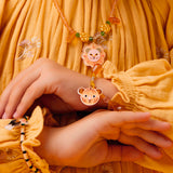 Child wearing a Deborah jungle collection necklace and bracelet with lion and tiger charms.