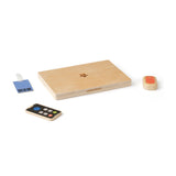 Wooden toy computer set with closed laptop, toy smartphone, mouse, and ID badge.