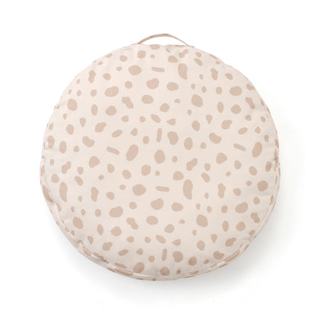 Round beige floor cushion with a subtle spotted pattern and carrying handle on a white background.