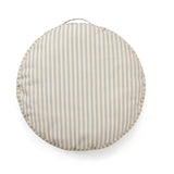 Round floor cushion featuring light grey and beige vertical stripes with a fabric handle on top.