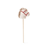 Plush spotted hobby horse toy on a wooden stick with a red bridle, against a white background.