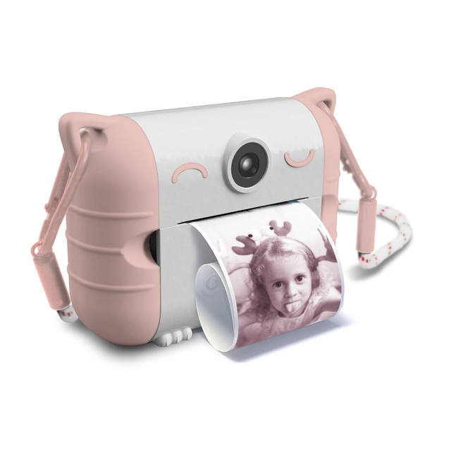 Cute pink and white toy camera with cat ears, printing a black and white photo of a child smiling. The design is playful and whimsical.