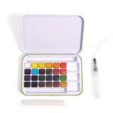 Open watercolor set with 24 colorful square pans inside a white case. Includes a water brush and sponge, creating a clean, organized artistic feel.