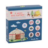 Box cover for a children's observation game titled "Je monte mon campement!" showing a yurt, animals, camping icons, and playfully illustrated items.