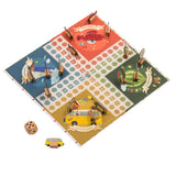 A colorful board game depicting four themed quadrants: red, green, blue, and yellow. Wooden pieces and a dice are placed around the board.