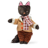 Les Minouchkas Leon the cat plush toy wearing a yellow patterned jacket, scarf, and brown pants.
