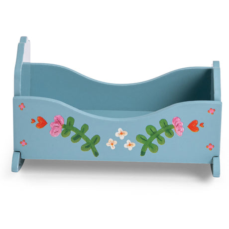 Blue wooden toy rocking cradle for Les Minouchkas dolls, side view with painted flowers and hearts.
