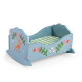 Blue wooden toy cradle painted with a deer and flowers for Les Minouchkas dolls.