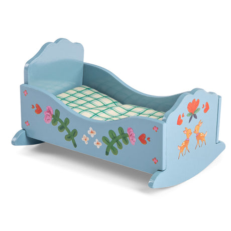 Blue wooden toy cradle with painted flowers and deer for Les Minouchkas dolls, featuring plaid bedding.