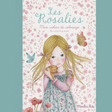 Young girl with long blonde hair, holding a kitten, surrounded by butterflies and flowers. The title "Les Rosalies" appears above. Soft, whimsical tone.