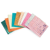 Colorful fan display of geometric and textured mosaic tiles in iridescent pink, teal, gold, and orange.