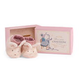 Pink plush mouse baby slippers for dance school next to a decorative matching gift box.