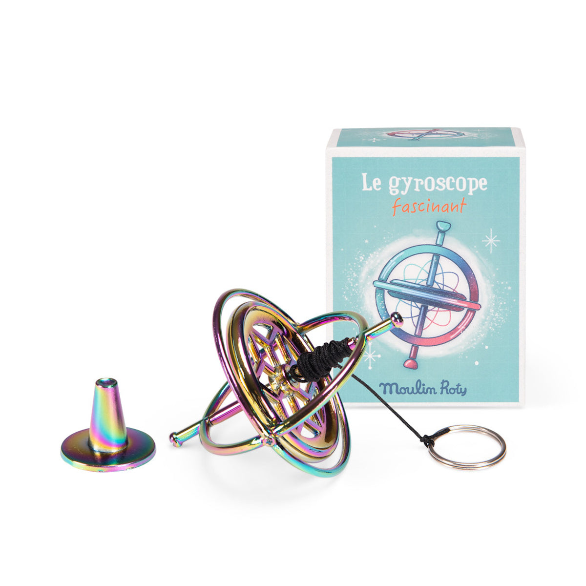 Moulin Roty iridescent metal gyroscope toy with string and stand next to its illustrated blue box.
