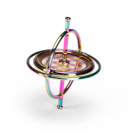 Rainbow metal gyroscope spinning top toy balanced on a white background.