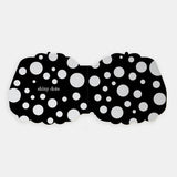 Shaped board book spread showing "shiny dots" featured as silver foil circles across a black background.