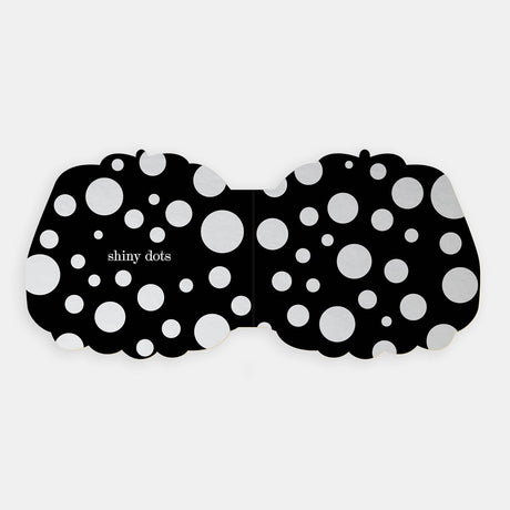 Shaped board book spread showing "shiny dots" featured as silver foil circles across a black background.