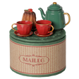 Maileg Christmas tea party set with a green teapot, red teacups, and a bundt cake on a decorative box.