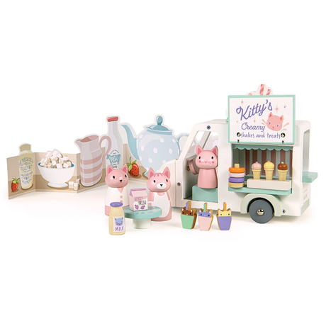 Wooden toy milkshake van with cat figures set against a printed kitchen backdrop.