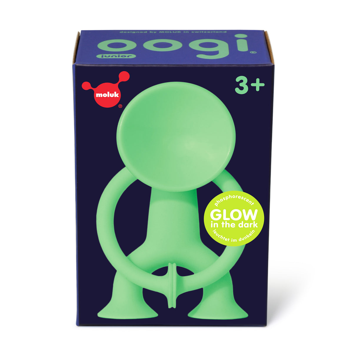 Box of a glow-in-the-dark green toy figure with suction cup limbs. Marked for ages 3+, with "oogi junior" and "moluk" branding on a dark blue box.