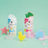 Two colorful bath salt containers with foam, adorned with playful illustrations, are surrounded by a pink star, yellow duck, and blue house sponges.