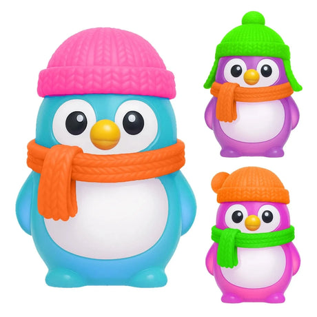 Three NeeDoh Polar Glow Penguins in blue, purple, and pink wearing colorful knit hats and scarves squishy fidget toys.