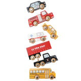 Six wooden toy vehicles arranged in a dynamic, scattered line on a white background.