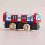 Red, white, and blue wooden toy train carriage on a light background.