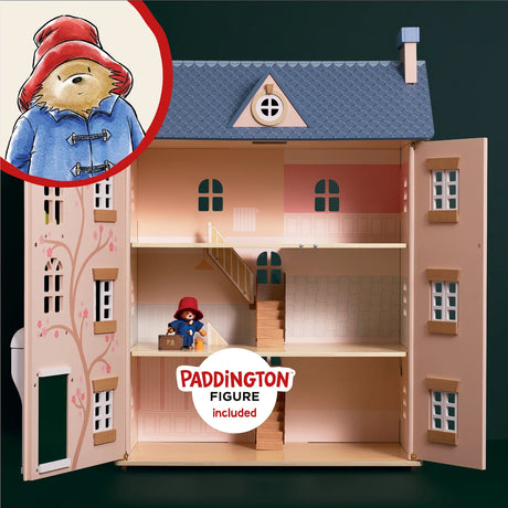 Open wooden dollhouse showing three floors and stairs, with a Paddington Bear figure inside.