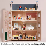 Open dollhouse with furniture and wooden figure characters on three floors, plus Paddington on the top level.