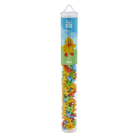 A clear cylindrical tube labeled "Plus Plus Chick" containing colorful interlocking building pieces in yellow, red, blue, and green. Playful and inviting.