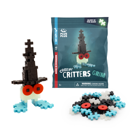 Building toy set named "Creepy Critters Grim" with glow-in-the-dark feature. Includes black, white, and blue pieces, plus red eyes. Fun and playful.