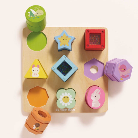 Wooden rainbow sensory shape sorter puzzle with colorful animal and flower blocks.