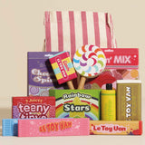 Wooden retro sweet and candy roleplay set displayed in front of a pink striped drawstring bag.
