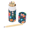 A colorful cylindrical box with vibrant floral and fairy patterns holds sharpened colored pencils. One pencil lies outside, creating a playful and creative vibe.