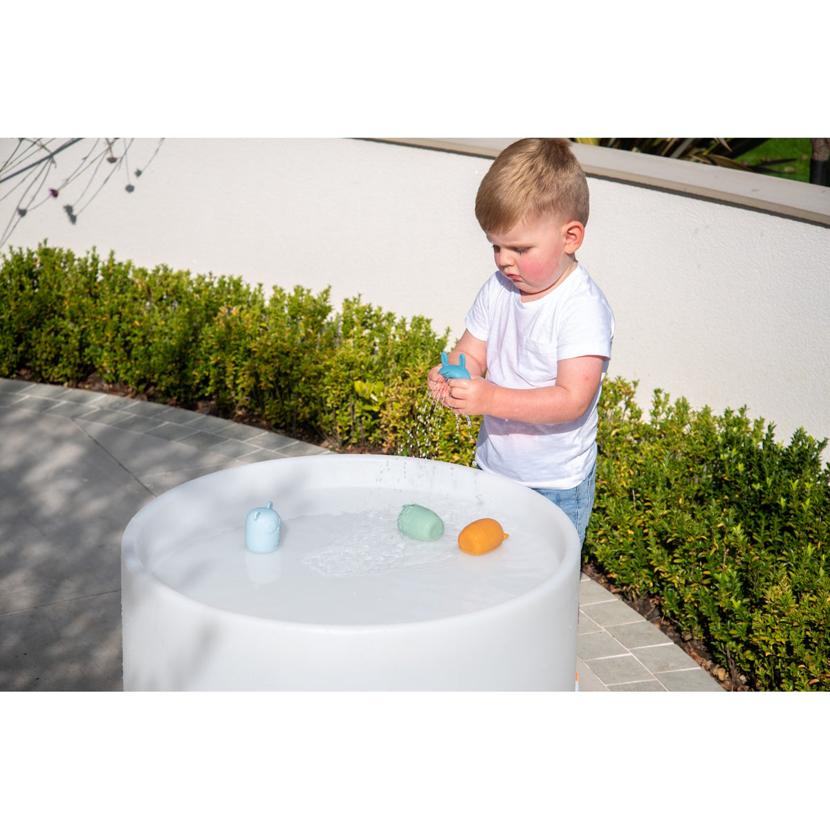A set of soft silicone animal-shaped squirters in neutral tones, designed for sensory play and water-based fun, perfect for young children.