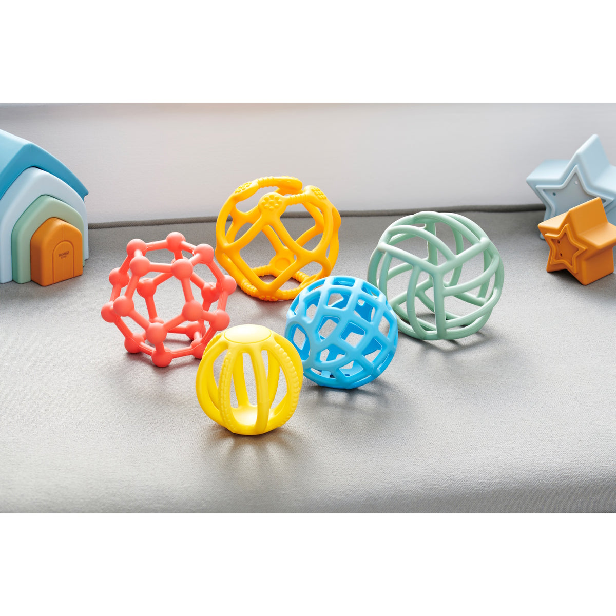 A set of colorful, soft silicone balls with a flexible texture, designed to promote sensory play and tactile exploration.