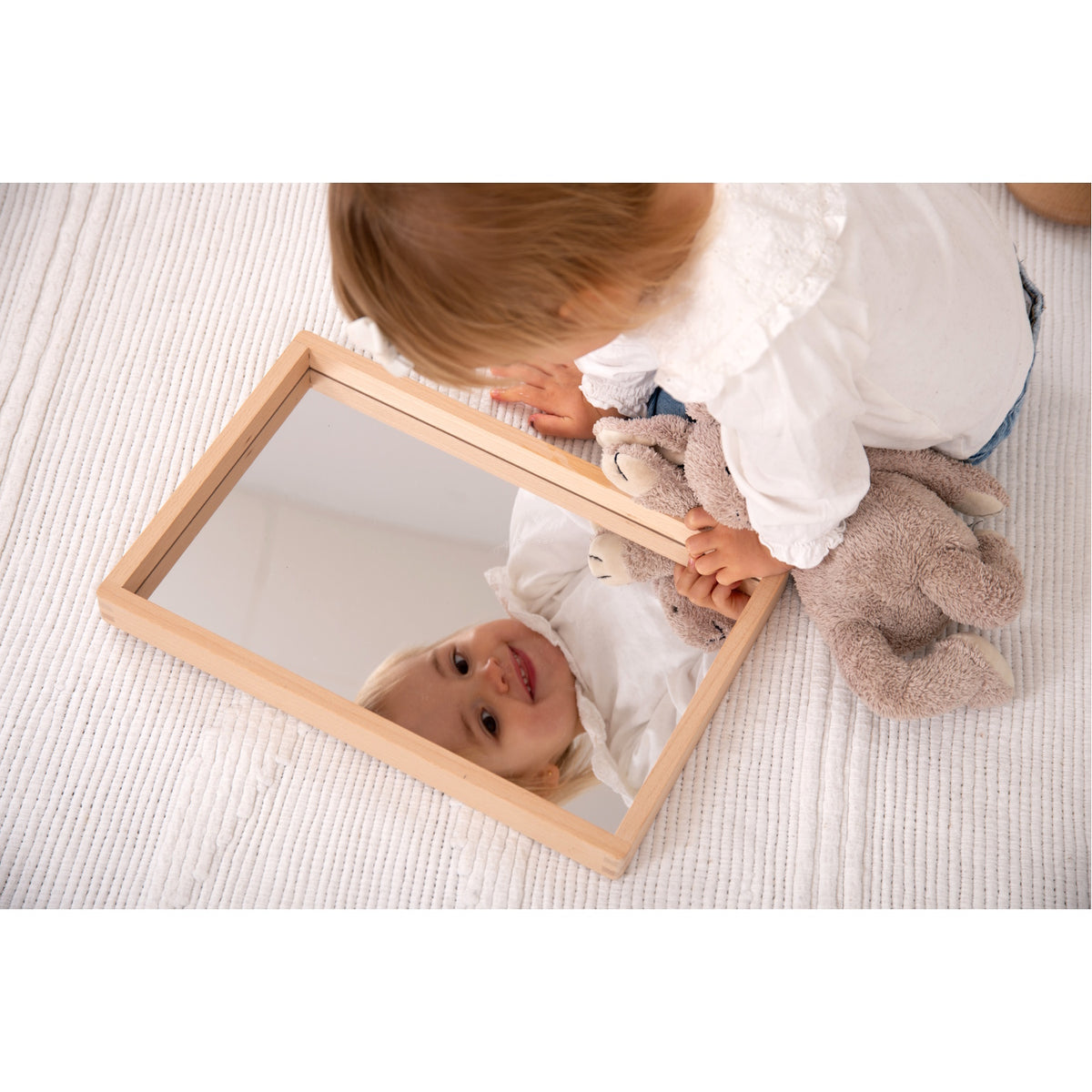 A compact wooden tray with a mirrored base, perfect for sensory play, loose parts exploration, and visual perception activities.