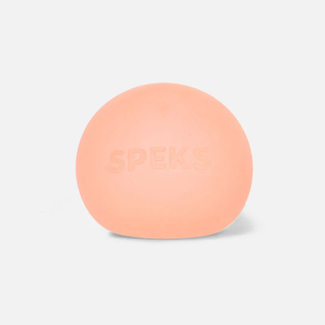 A soft, rounded, peach-colored stress ball with "SPEKS" subtly embossed on the front. The background is white, conveying a calm, minimalistic tone.