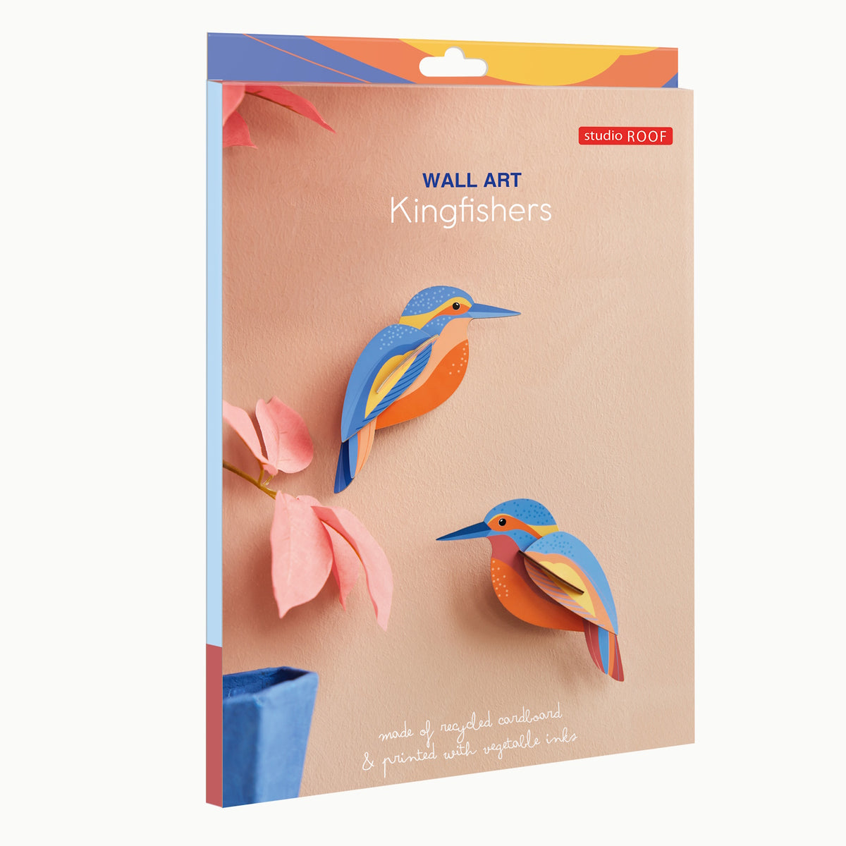 Packaging for wall art featuring colorful, stylized kingfishers made from recycled cardboard. Includes pink leaves and a blue vase for decoration.