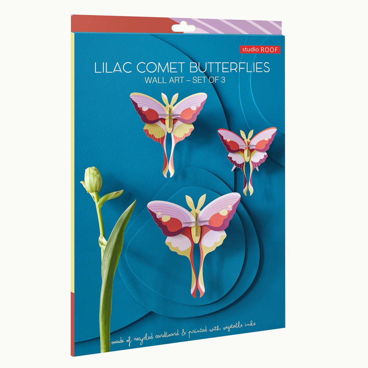 Cardboard wall art set featuring three colorful Lilac Comet Butterflies on a blue background. Includes a flower stem on the left. Bright and vibrant.